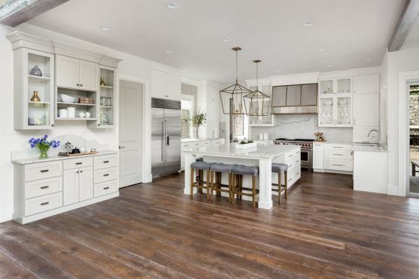 Bright kitchen with white cabinets and hardwood flooring, exemplifying modern style in Austin, TX.